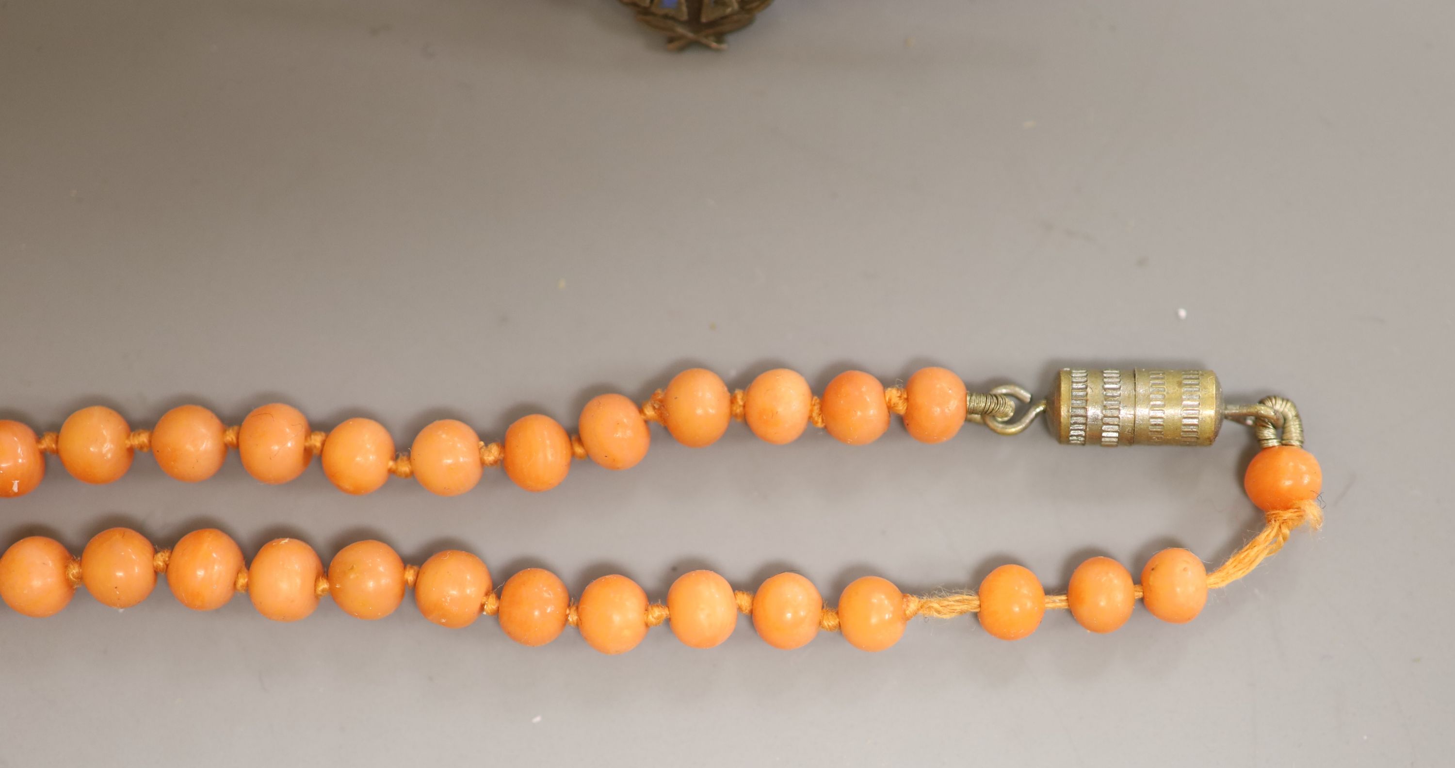 A lady's Longines gold plated and steel quartz wristwatch, one other watch, a coral bead necklace, badges etc.